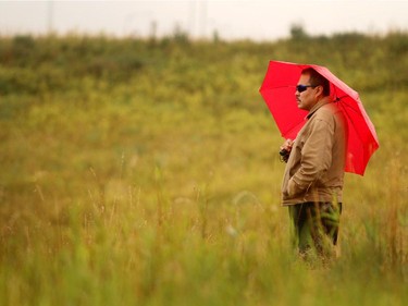 Colton Crowshoe's father Jimmy Crowshoe watched as members of the Calgary Fire Department dive team searched for clues in the retention pond on the southwest corner of Stoney Trail and 16th Avenue on September 14, 2015. The dive team returned to the site to help the Calgary Police Service Homicide Unit in searching for additional evidence in the death of Crowshoe last year.
