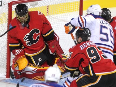 Calgary Flames goalie Jonas Hiller kept his eye on the puck in traffic after a shot by the Edmonton Oilers during the first period of a split squad preseason NHL game at the Scotiabank Saddledome on September 21, 2015.
