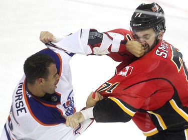 Edmonton Oilers defenceman Darnell Nurse laid a punch on the nose of Calgary Flames right winger Hunter Smith during the second period of a split squad preseason NHL game at the Scotiabank Saddledome on September 21, 2015.