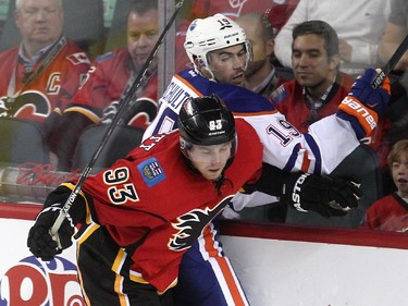 Calgary Flames centre Sam Bennett drove Edmonton Oilers defenceman Justin Schultz into the boards during the third period of a split squad preseason NHL game at the Scotiabank Saddledome on September 21, 2015. The Flames lost 3-1 to the Oilers.