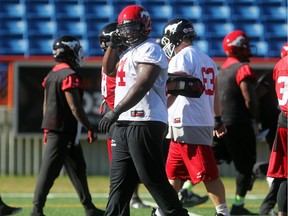 Calgary Stampeders offensive lineman Derek Dennis walks off the field after running through plays with teammates during practice at McMahon Stadium on Wednesday. He has only been with the team just over a week but will draw the left tackle start against Hamilton on Friday night.