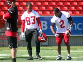 Calgary Stampeders injured return man Tim Brown, right, offers some pointers to his replacement, Nathan Slaughter, during practice at McMahon Stadium on Wednesday.