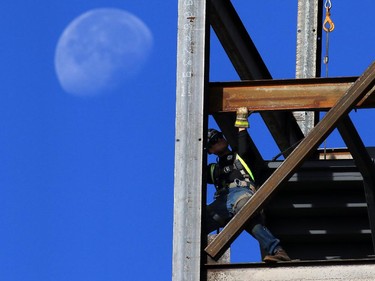 Construction workers work on the steel frame of the new Hilton Garden Hotel being built in the East Village.