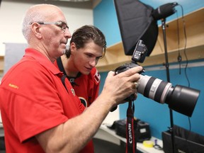 Calgary Flames forward Joe Colborne checks out his portrait with photographer Brad Watson at WinSport on Thursday.