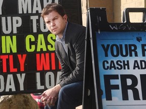 Mike Brown, public policy co-ordinator with Momentum, a non-profit that teaches financial literacy to low income earners, outside a payday loans service in Calgary on Sept. 25, 2015.