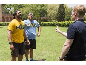 Nick, left, and Matt are greeted by host Jon Montgomery on the mat at the Pit Stop in Delhi, India on The Amazing Race Canada.