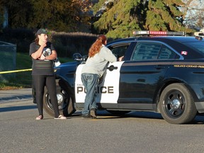 Residents speak with police at the scene of a suspicious death in Dover Wednesday morning.