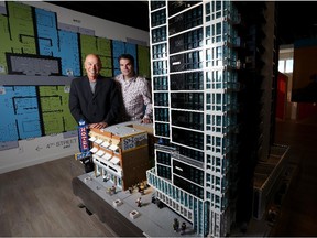 Joseph Starkman, left, of Knightsbridge, and lego artist Dave Ware pose with a lego modelof the N3 condo at the N3 Presentation Centre in Calgary on September 11, 2015.