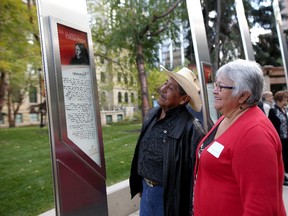 Mario Provost, left, and Amelia Crowfoot Clarke look at the plaque dedicated to their great great grandfather, Chief Crowfoot, unveiled during the Alberta Champions event at the McDougall Centre on September 17, 2015.