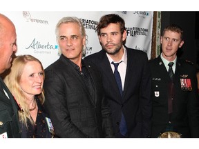 Director and star Paul Gross and co-star Rossif Sutherland, are joined on the red carpet by Canadian Military members, from left, Lieutenant-Colonel Ross Wickware, retired Major Patricia Murphy both of the Kings Own Calgary Regiment and, right, Piper Kevin Ponte of the Calgary Highlanders at Theatre Grand Junction for the opening of Hyena Road at the Calgary Film Festival Thursday evening September 24, 2015.  (Ted Rhodes/Calgary Herald)