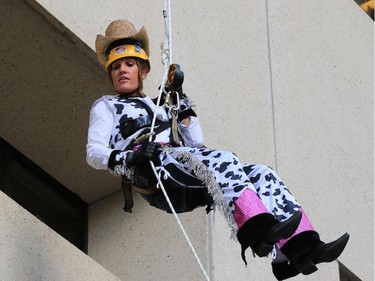 Sharon Schille nears the ground as she finishes rappelling down the side of the 30 story Sun Life Plaza building during the Easter Seals Drop Zone charity rappel on Thursday morning September 3, 2015.