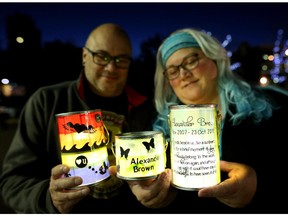 Jonathan and Tara Brown hold the lanterns they made in memory of their two-year-old son Alexander, who passed a way from a rare brain cancer in 2010, during the ceremony Time to Remember at Eau Claire Market in Calgary. The vigil took place Wednesday, Sept. 30, 2015.
