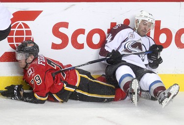 Calgary Flames Micheal Ferland, left, collides with Colorado Avalanche Marc-Andre Cliche during pre-season action at the Scotiabank Saddledome.