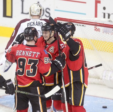 Calgary Flames Jiri Hudler, middle, celebrates his second goal on the Colorado Avalanche with teammates during pre-season action at the Scotiabank Saddledome.