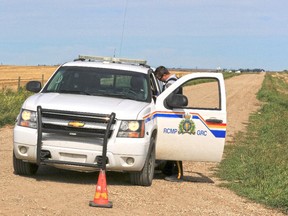 RCMP block off the intersection of Range Road 283 and Township Road 280 northeast of Airdrie after a body was found in a burnt out vehicle on Range Road 283 on Friday, September 18, 2015.