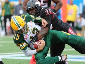 Charleston Hughes sacks Eskimos quarterback Mike Reilly during the second half of the Labour Day Classic at McMahon Stadium on Monday.