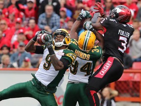 Edmonton Eskimos Patrick Watkins, left and Ryan Hinds intercept a pass intended for wide receiver Jeff Fuller during Monday's Labour Day Classic at McMahon Stadium. The Stamps offence was largely held in check but Calgary's defence led the way in a 16-7 win.