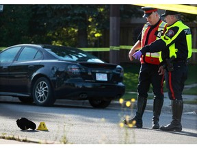 Police investigate the scene of a fatal collision between an SUV and a pedestrian on Erin Woods Boulevard near Erin Woods Place S.E. on Friday morning, Sept. 18, 2015.