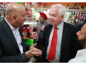 Federal Liberal candidate for Markham-Thornhill John McCallum, centre, talks with Taranjeet Aujla following a press conference about the Liberal plan for Canadian immigration at the Sanjha Punjab Grocery in northeast Calgary on Tuesday, Sept. 29, 2015.