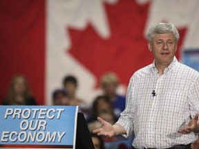 Prime Minister Stephen Harper speaks with Conservative Party supporters at a campaign rally during a stop in Calgary, on September 15, 2015.