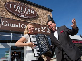 Penny Sandborn, accordion player, and Tony Rino, operatic singer, perform in front of the Italian Centre Shop as the business hosts its grand opening event.
