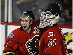 Calgary Flames goalie Karri Ramo, right, and Kris Russell celebrates following third period NHL first round game six playoff hockey action against the Vancouver Canucks in Calgary, Saturday, April 25, 2015. For the Flames to extend their Cinderella run in the NHL playoffs, they'll need to conquer the hostile Honda Centre.The Flames open their best-of-seven Western Conference semifinal series on the road this week against the Anaheim Ducks.