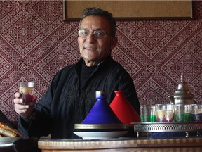 Ismaili, chef and owner of Sultan's Tent holds a cup of Moroccan tea in the meknes dining area .