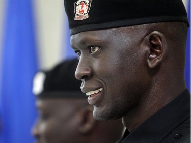 Stephen Deng who came to Canada from war torn Sudan, smiles during graduation with the Calgary Police Auxilliary Cadet Program Friday June 12, 2015 at HMS Tecumseh.