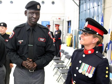 Stephen Deng who came to Canada from war torn Sudan, chats with his mentor Sergeant Clare Smart with the Calgary Police Auxilliary Cadet Program Friday June 12, 2015 at HMS Tecumseh.