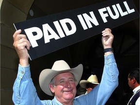 Premier Ralph Klein declares the Alberta debt paid off in 2004.