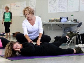 Somatics instructor Martha Peterson, white shirt, works with student Evelyn McGhee, in a workshop in Calgary.