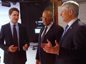 Liberal Leader Justin Trudeau, New Democratic Party Leader Thomas Mulcair and Conservative Leader Stephen Harper confer before the Maclean's National Leaders debate in Toronto, Aug.  6, 2015.