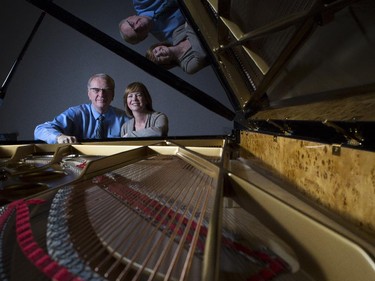 Michael and Nicole Lipnicki, owners of Lipnicki Fine Pianos, pose at the Faziolo piano chosen by the Honens winner in their shop in Calgary, on September 16, 2015.