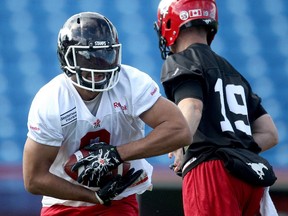 Calgary Stampeders running back Jon Cornish takes off with a handoff from quarterback Bo Levi Mitchell during practice on Tuesday.