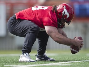Calgary Stampeders defensive lineman Brandon Tett takes long snaps during practice on Tuesday.