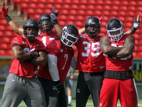 Calgary Stampeders, from left, defensive lineman Freddie Bishop III, linebacker Juwan Simpson, defensive linemen Junior Turner, Charleston Hughes and Micah Johnson hammed it up during practice on Thursday at McMahon Stadium. The team is busy preparing for the Labour Day Classic on Monday against Edmonton.