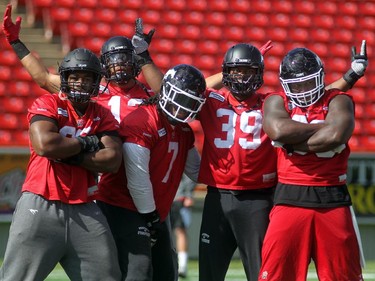 Calgary Stampeders, from left, defensive lineman Freddie Bishop III, linebacker Juwan Simpson, defensive linemen Junior Turner, Charleston Hughes and Micah Johnson hammed it up during practice on September 3, 2015 at McMahon Stadium. The team is busy preparing for the Labour Day Classic on Monday against Edmonton.