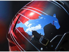 Blue skies are reflected in a Calgary Stampeders helmet on Wednesday September 2, 2015.