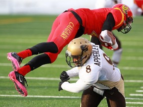Calgary Dinos receiver Rashaun Simonise goes over the top of Manitoba Bison Tremaine Apperley during the Hardy Cup Canada West championship last fall. Calgary was upset 27-15 in the match.