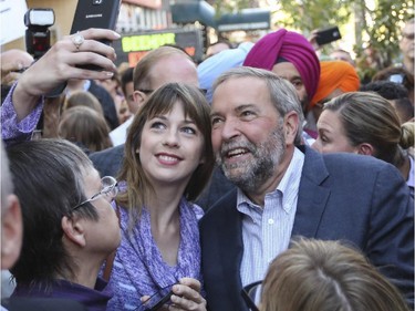 NDP federal leader Thomas Mulcair gets a selfie taken by a supporter while making a campaign stop in Calgary, on September 15, 2015.