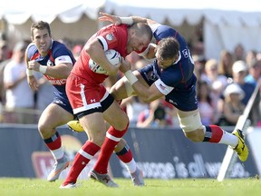 Calgary's Nick Blevins of Team Canada tries to keep Team USA's Al McFarland (right) from the ball during the first half of an international rugby test match in Ottawa last month.