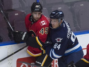 Morgan Klimchuk of the Calgary Flames prospects battles with Winnipeg Jets' Peter Stoykewych during the YoungStars Classic in Penticton, B.C. Klimchuk carried over his strong play from that tournament into Wednesday's exhibition game against the University of Calgary Dinos.