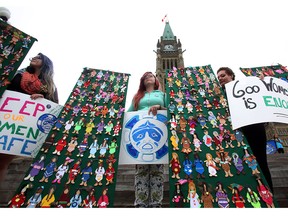 Women take part in a rally on Parliament Hill in Ottawa on Friday, October 4, 2013 by the Native Women's Association of Canada honouring the lives of missing and murdered aboriginal women and girls.