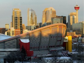 The Saddledome and the Calgary city skyline behind as seen at sunrise.