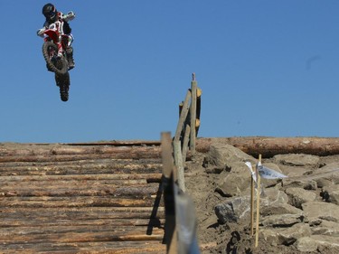 Spencer Wilton, of the junior category, flies off a jump as he competes in Canada's only Urban Endurocross Challenge, the Red Bull Rocks & Logs at Wild Rose MX park in Calgary, on September 12, 2015.