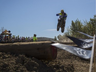 Ben Rego, of the amateur category, flies through the air as he competes in Canada's only Urban Endurocross Challenge, the Red Bull Rocks & Logs at Wild Rose MX park in Calgary, on September 12, 2015.