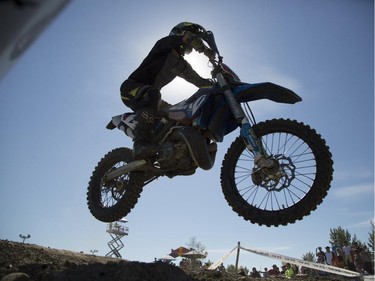 AJ Prockiw, of the amateur category, takes a tumble as he competes in Canada's only Urban Endurocross Challenge, the Red Bull Rocks & Logs at Wild Rose MX park in Calgary, on September 12, 2015.