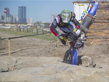 Mitch Brown, of the amateur category, takes a tumble as he competes in Canada's only Urban Endurocross Challenge, the Red Bull Rocks & Logs at Wild Rose MX park in Calgary, on September 12, 2015.