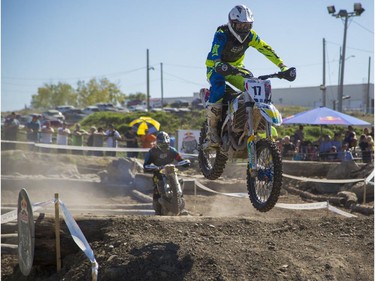 Kevin Dupuis, right, of the amateur category, competes in Canada's only Urban Endurocross Challenge, the Red Bull Rocks & Logs at Wild Rose MX park in Calgary, on September 12, 2015.