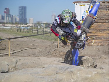 Mitch Brown, of the amateur category, takes a tumble as he competes in Canada's only Urban Endurocross Challenge, the Red Bull Rocks & Logs at Wild Rose MX park in Calgary, on September 12, 2015.